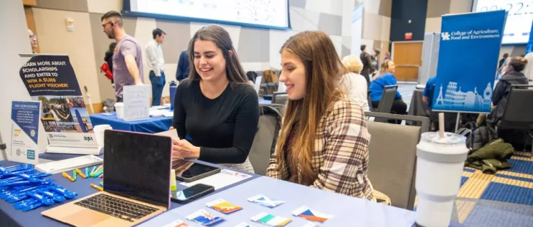 Students learn about education abroad opportunities at a table at the Education Abroad Fair