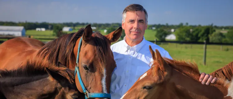 Dr. Brett Sponseller stands with horses