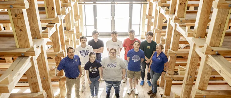 Distillation, Wine and Brewing Club members stand in the barrel room
