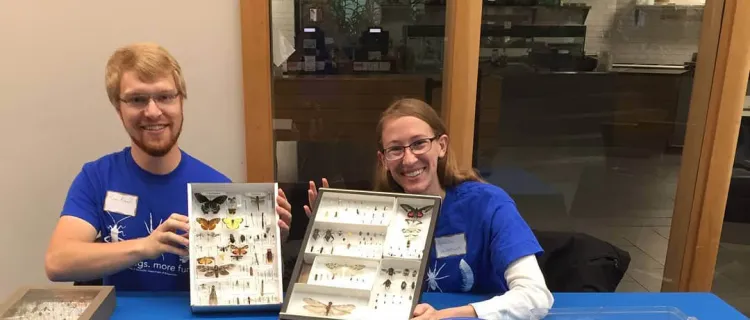 Entomology Club members work a table with insect specimens