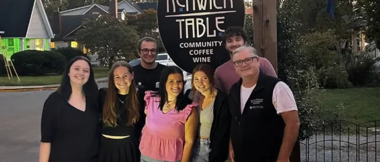 Hospitality Haven members stand with the Kenwick Table sign
