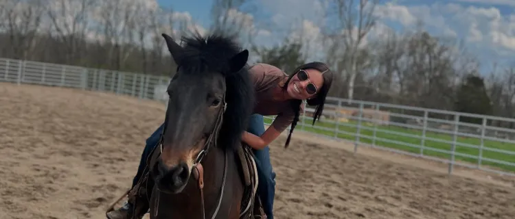 A UK Ranch Horse Team member rides a horse