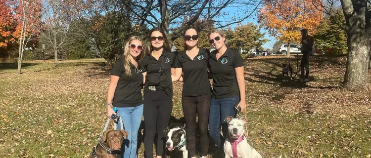 Waggin' N Walkin' members stand outside with dogs