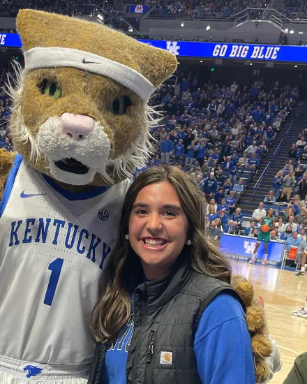 Caroline Groth with the Wildcat mascot at a basketball game