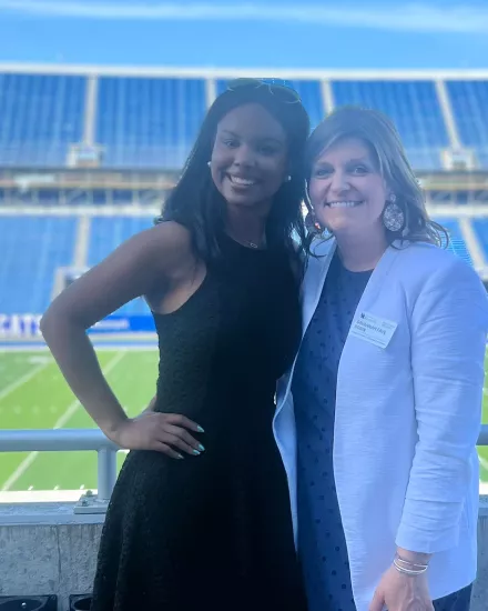 Lexi Robin with a woman at the football field
