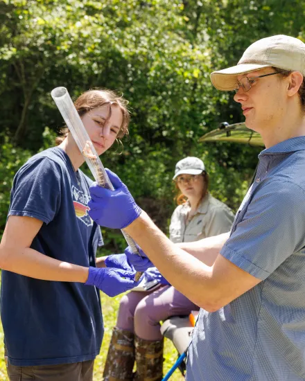 Student holding captured snake for study
