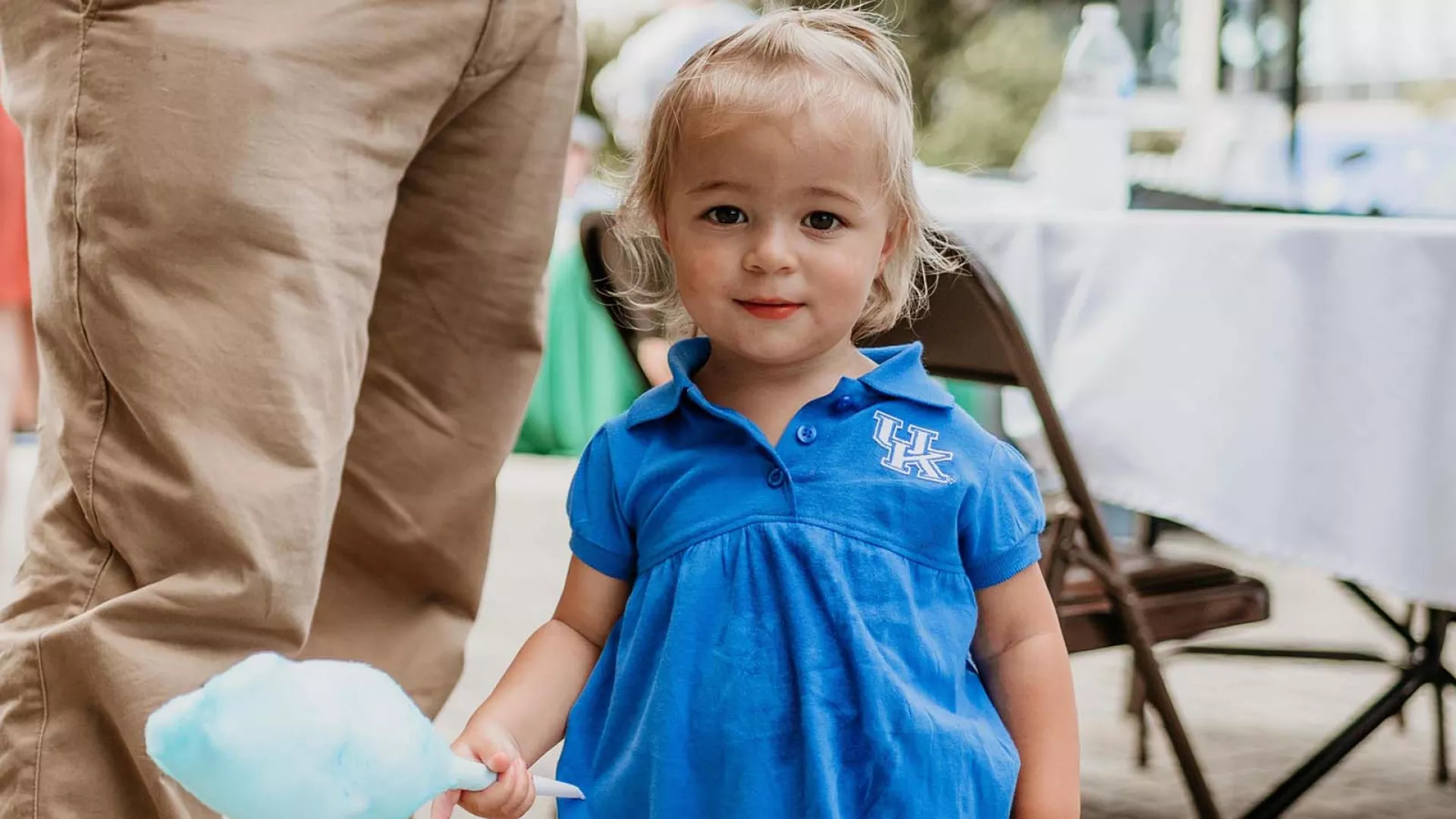 A child wears a UK outfit at a CAFE welcome event