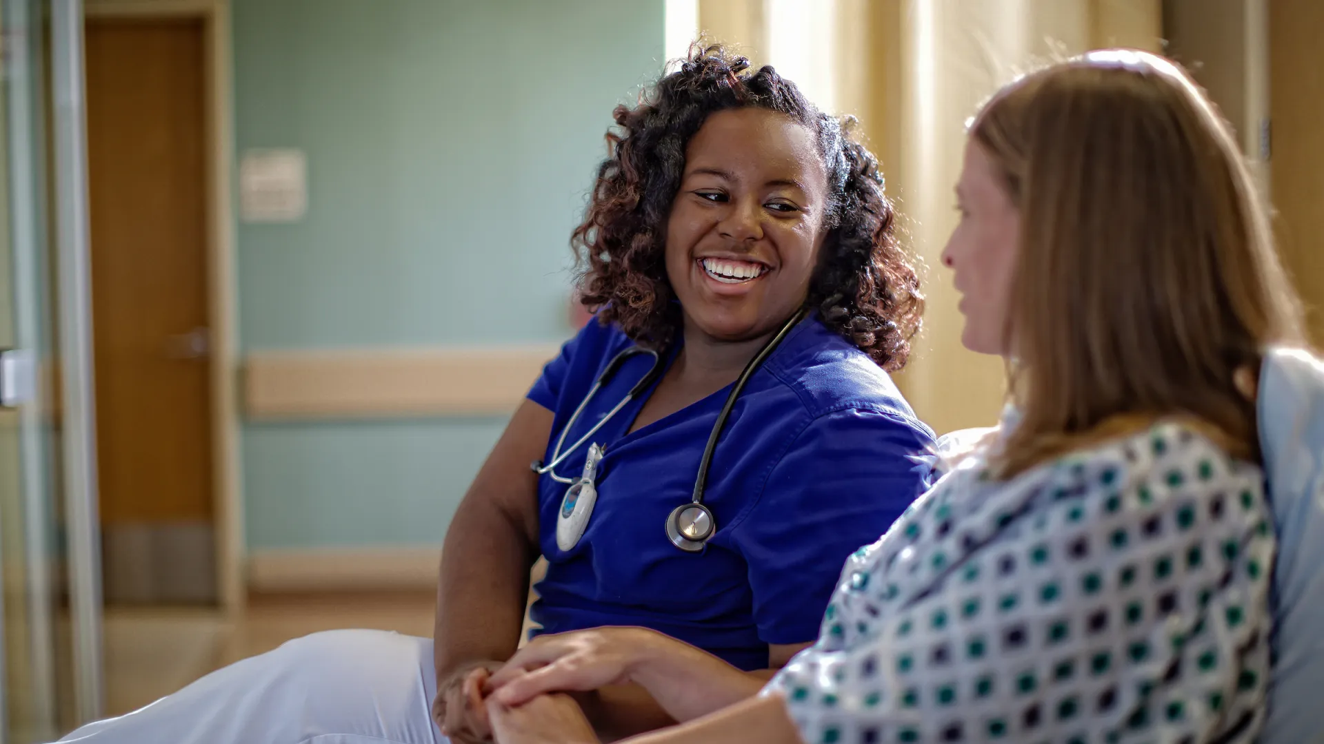 A physician assistant works with a patient