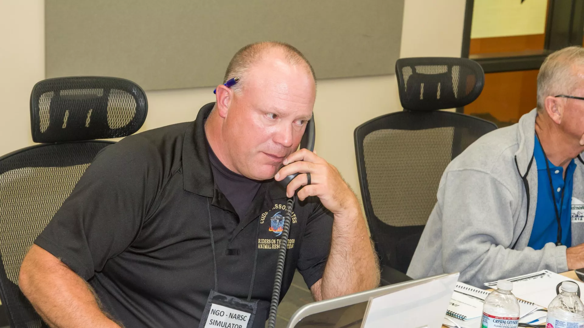 A man talks on the phone during a Multi-Jurisdictional Animal Coordination Exercise (MARCE), a Homeland Security Exercise and Evaluation Program (HSEEP) functional exercise.