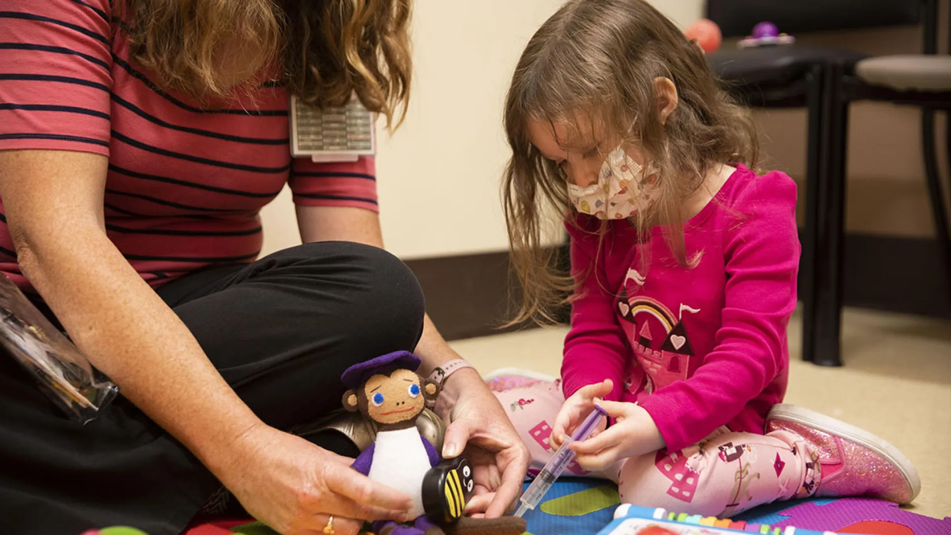 An adult and child play during therapy