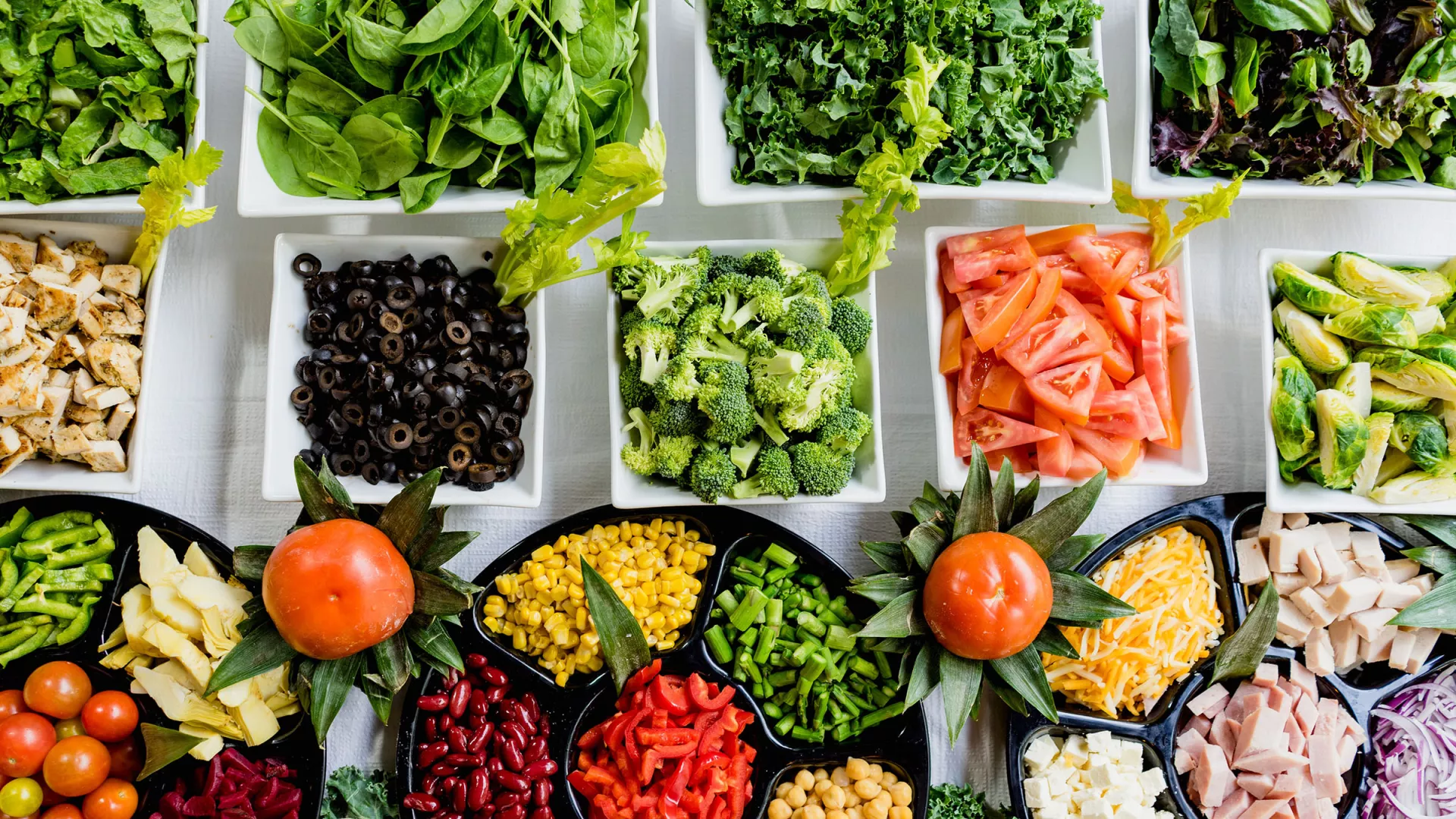 A table of vegetables and food trays