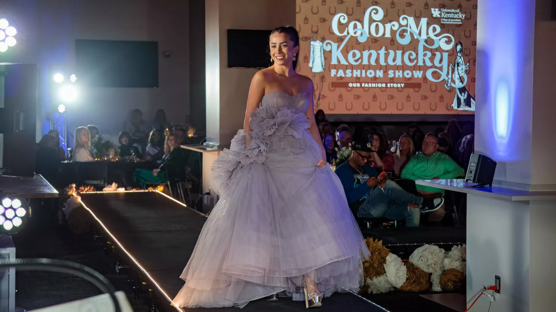 Student models showcase clothing trends on the runway of the Color Me Spring Fashion Show.