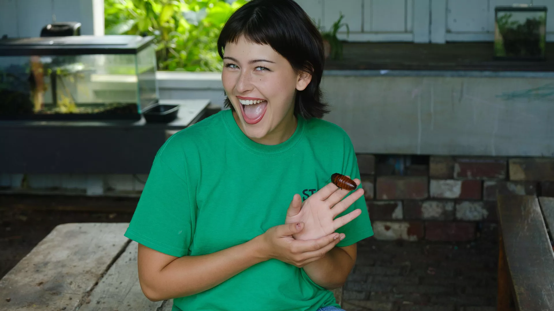 Student holding a beetle