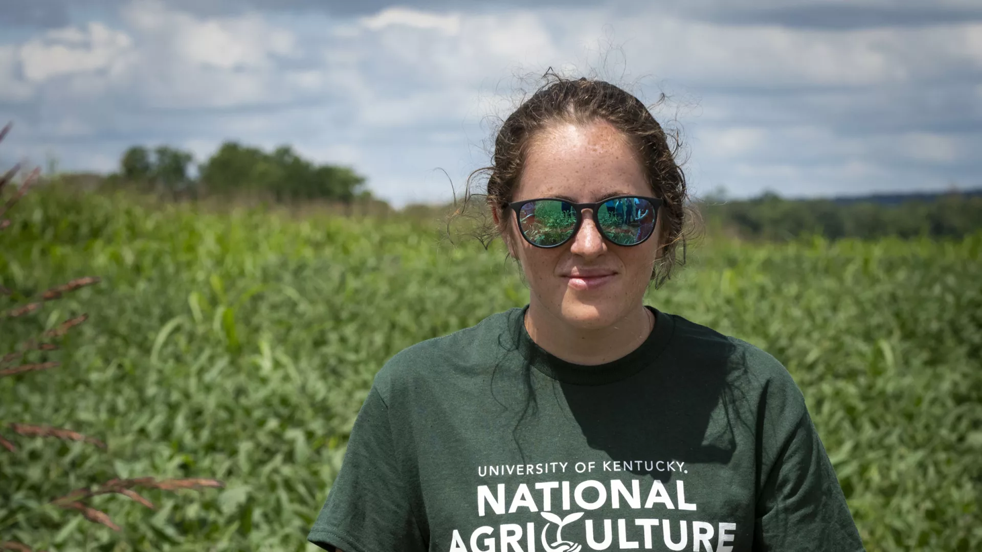 Agricultural Ecosystem Sciences Summer Experience Kate holding a Sunflower