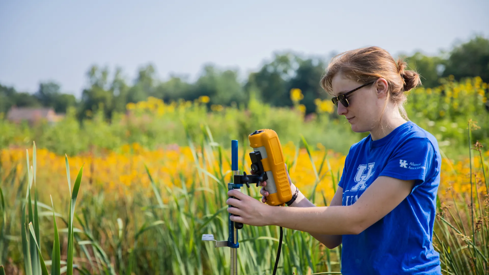 Student checking readings during Alumni Dr Stream Restoration Project