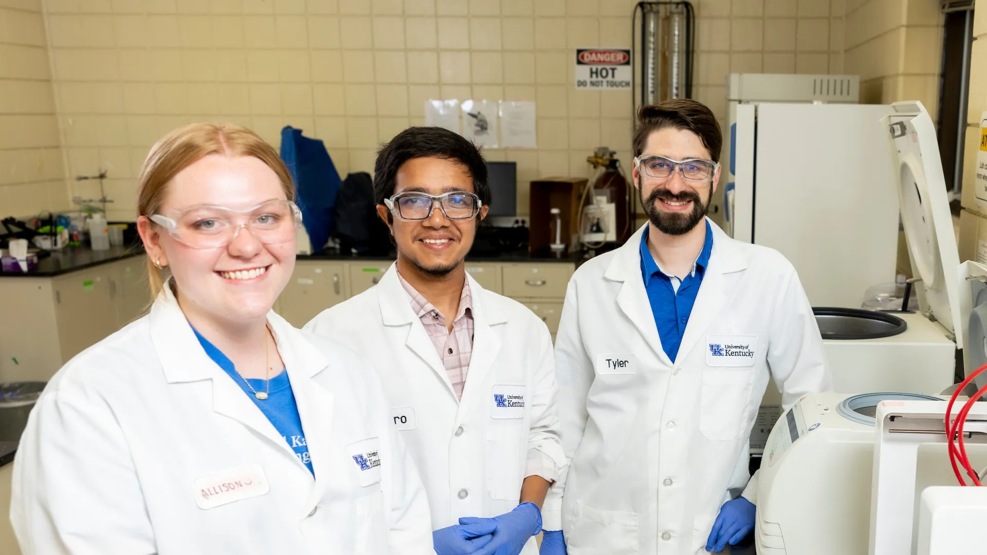 Three students work in a lab