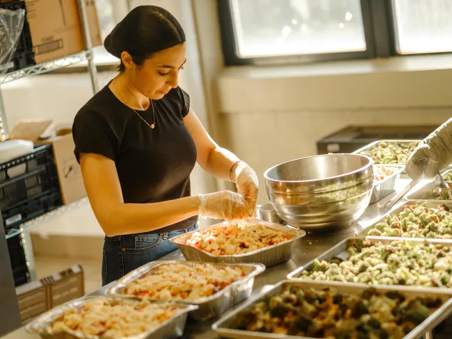 Campus Kitchen, Dietetics and Human Nutrition Dietetics and Human Nutrition student Tinia Mousa prepared food in the Campus Kitchen.