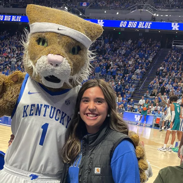 Caroline Groth with the Wildcat mascot at a basketball game