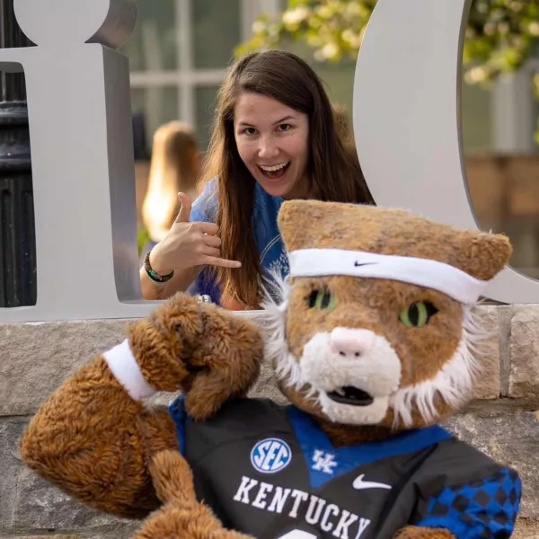Jenna Coles laughs with the Wildcat mascot