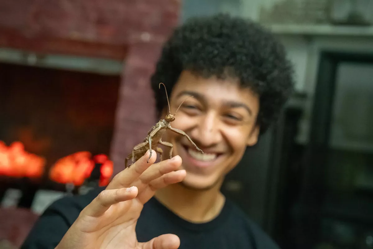 Student holding a mantis