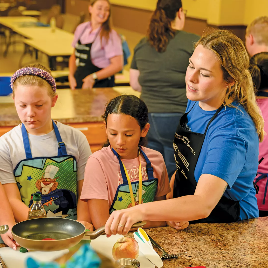 Abi McDonald cooks with children at cooking camp