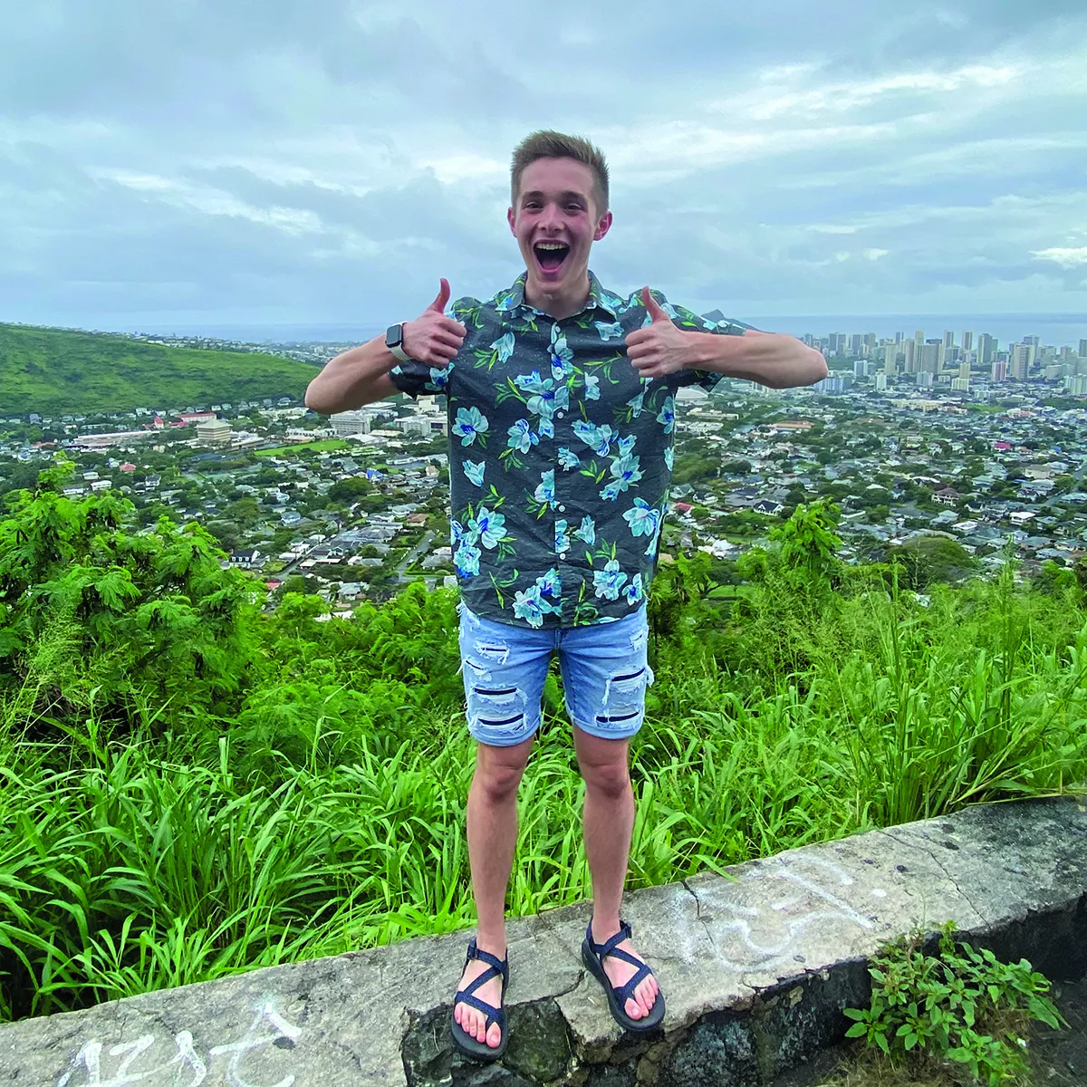 Jordan Colella stands in front of a view of a city