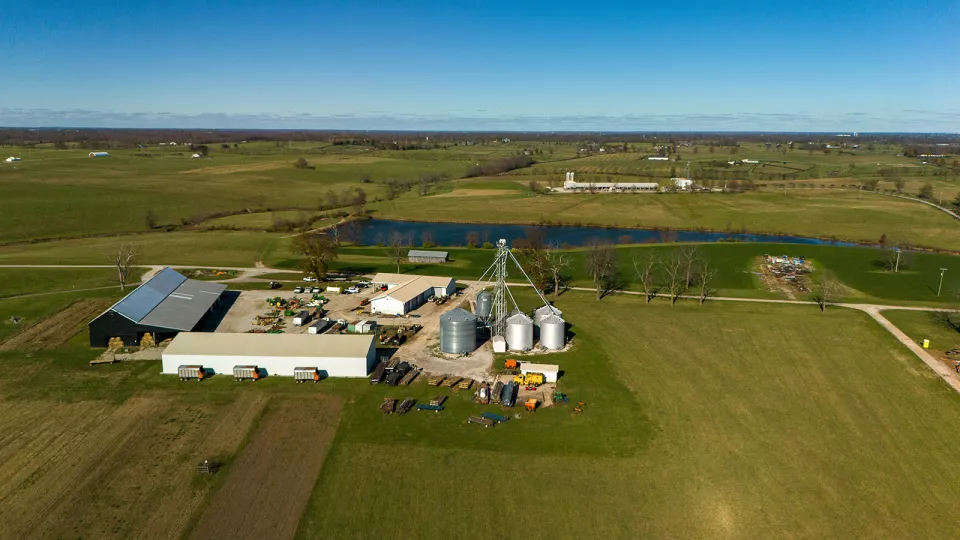 Aerial view of the grain bins and shop with the Sheep Research Unit across the lake on the C. Oran Little Research Farm.