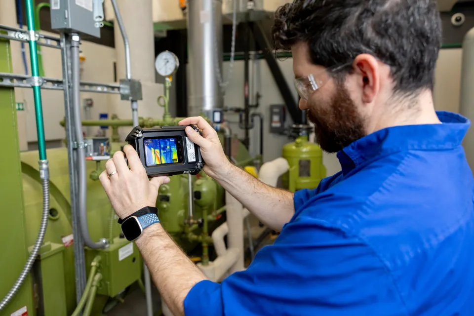 The James B. Beam Institute is leading a new program where neighboring distillers partner to find ways of saving on their utility bills. Brad Barron and Kevin Baldridge were photographed checking on energy output of distillery equipment at the James B. Beam Institute on October 23rd, 2024.